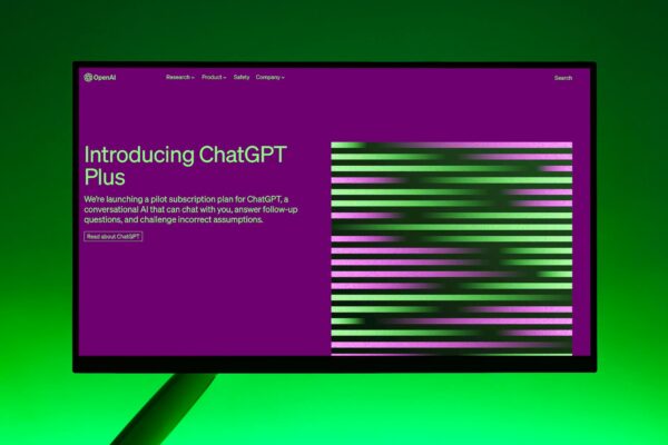 Close-up of a monitor displaying ChatGPT Plus introduction on a green background.