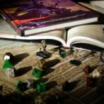 Close-up of tabletop RPG setup with books, dice, and figurines on a map.