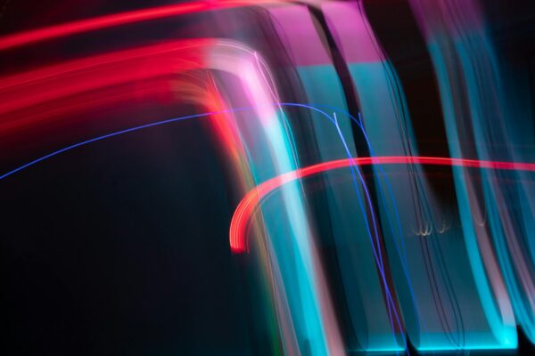 Dynamic and colorful long exposure light streaks in an abstract artistic composition.