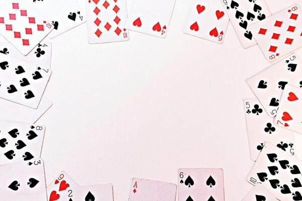 A circle of dispersed playing cards on a white surface, perfect for games and gambling themes.