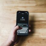 A person interacting with an AI assistant on a smartphone indoors.